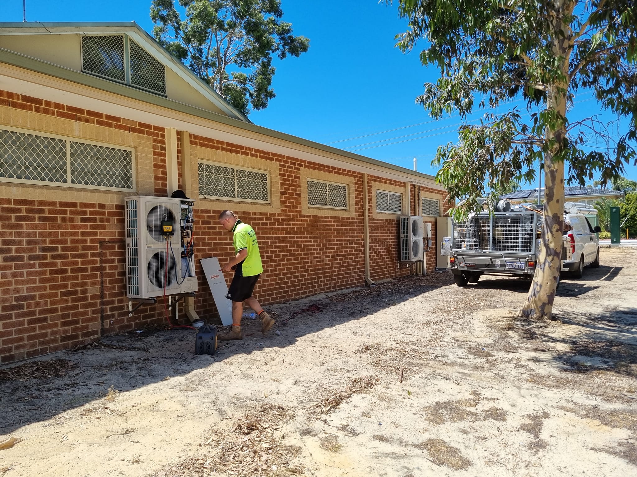 Perth Solar and Air technician servicing outdoor air-conditioning equipment